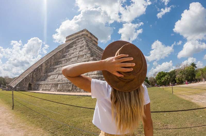 Photo of lady in front of a pyramid