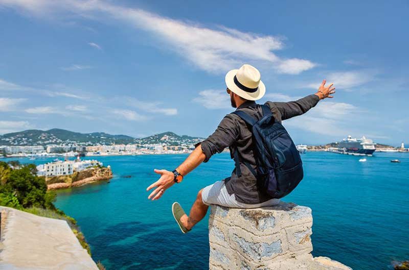 Photo of a man in front of a harbour
